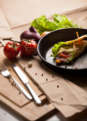 hot breakfast roll on cast-iron pan close up