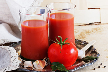 Tomatoes and glass of tomato juice