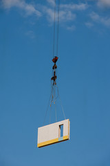 Fototapeta premium Concrete plate on crane hook