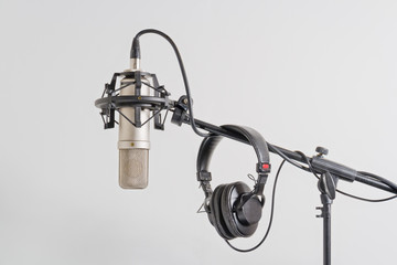 Professional  microphone with headphones on a stand. - obrazy, fototapety, plakaty