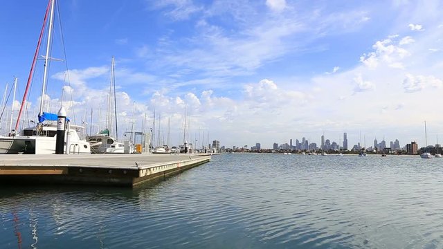 beautiful dock in the port of the city of Melbourne and many boats are on the quay in the Port Phillip and the city can be seen on the horizon and the beautiful calm blue water