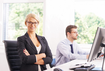 Female office worker in formalwear with her colleague
