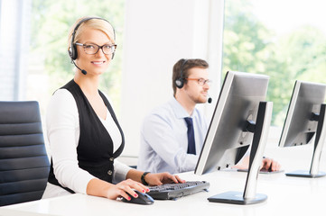 Customer support operators in formalwear working in a call cente