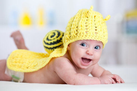 happy baby child in costume of snail
