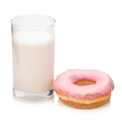 Milk in the glass and donut on white background