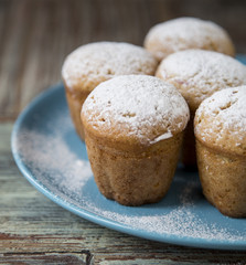 Freshly baked homemade muffins with powdered sugar