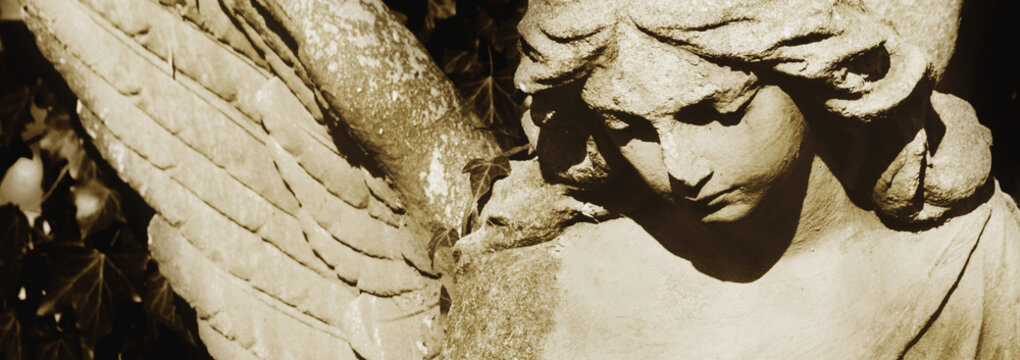 Vintage image of a sad angel on a cemetery
