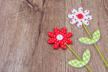 Creative handmade flowers on a wooden background