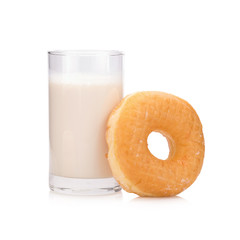 Milk in the glass and donut on white background