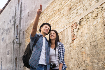 Fototapeta na wymiar Young couple exploring the old town