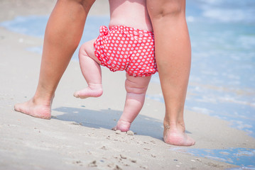 Baby walking on a beach