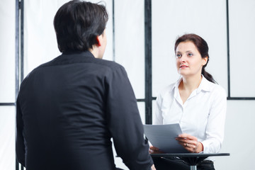 woman inverviewing a man for a job