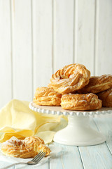 Sweet eclairs on a white wooden table