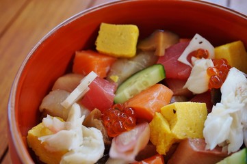Bowl of chirashi sushi with mixed raw fish and salmon roe over rice