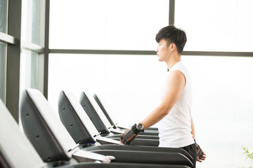 Fototapeta premium young handsome asian man works out in modern gym