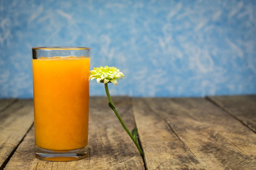 Fresh orange juice on wooden table