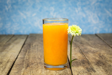 Fresh orange juice on wooden table