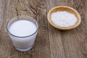 Coconut milk and the dish with grated coconut