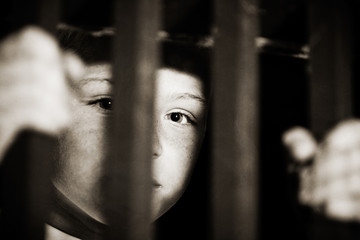 Imprisoned child behind bars