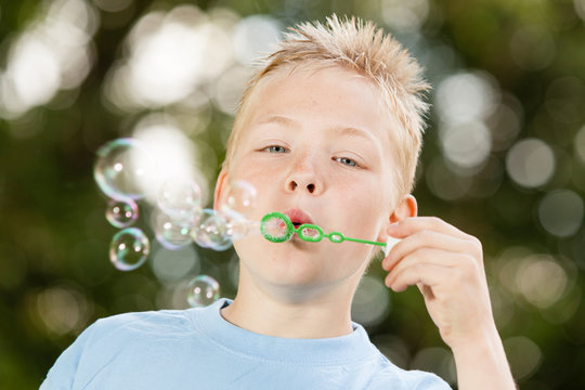 Cute Boy Blowing Bubbles