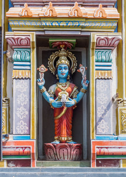 Trichy, India - October 15, 2013: Statue of Vishnu-Durga in her own shrine. Blue skin and carrying the conch and the discus, and pours milk.  Powerful image of Vaishnavism.