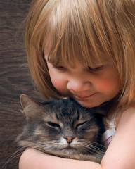Portrait of a teen girl with a cat. The girl smiles. The face and muzzle close