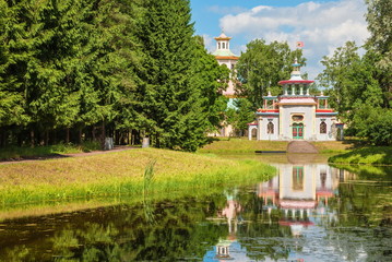 Fototapeta na wymiar Exotic pavilion, called Chinese (squeaky) gazebo located on picturesque shore of pond in a park in Tsarskoye Selo