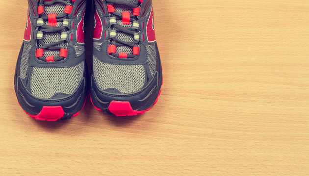 Running sneakers on wooden background