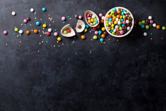 Colorful candies on stone background