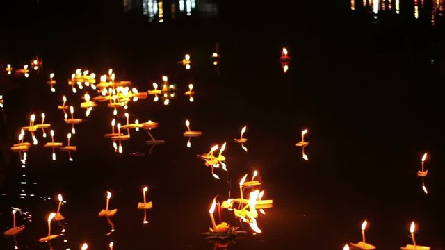 Loi Krathong festival in Chiangmai Thailand, floating basket of flowers on river during celebrated on Thai full moon lunar calendar