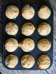Healthy muffins with jam on wooden table