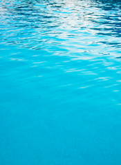 Blue pool water with sun reflections