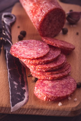 Sliced salami on cutting board closeup