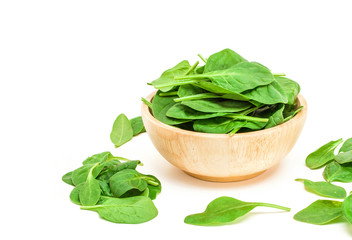 spinach leaf in wooden bowl isolated on white background