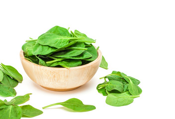 spinach leaf in wooden bowl isolated on white background
