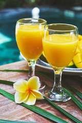 Glasses of fresh tropical smoothie or mango juice