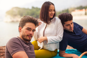 Obraz premium Three friends having fun at the beach, springtime