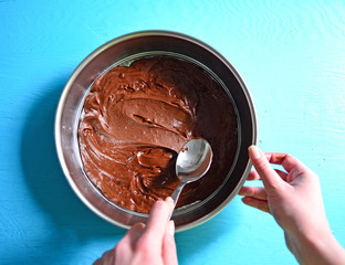 Woman hand smearing chocolate cream