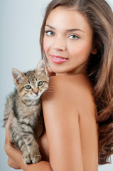 Girl with a kitten. Young woman with pet
