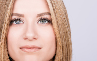 Fototapeta premium Closeup portrait of the face of a young woman, expressive eyes,