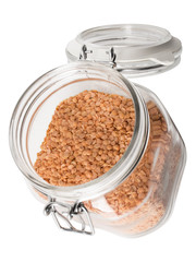 angled view of red lentils in a jar.