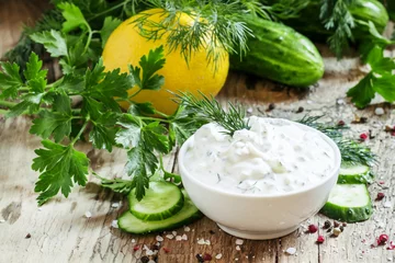 Foto auf Leinwand Ranch sauce in a white porcelain bowl with vegetables, herbs and © 5ph