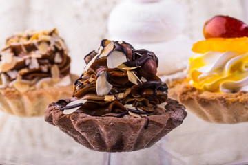 Tasty cakes on a transparent plate