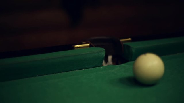 Billiards table and balls, strike the cue ball and falling in the pocket
