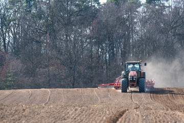 Tractor harrowing the field