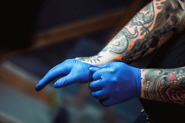 master tattoo artist prepares tools for tattooing