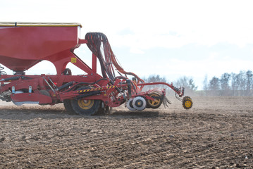 Tractor harrowing the field