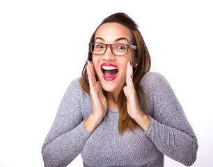 young woman looking excited against white background