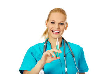 Smiling female doctor or nurse with stethoscope holding syringe