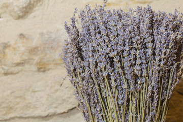 Dry scented decoration lavanda purple plants on a yellow stoned background
